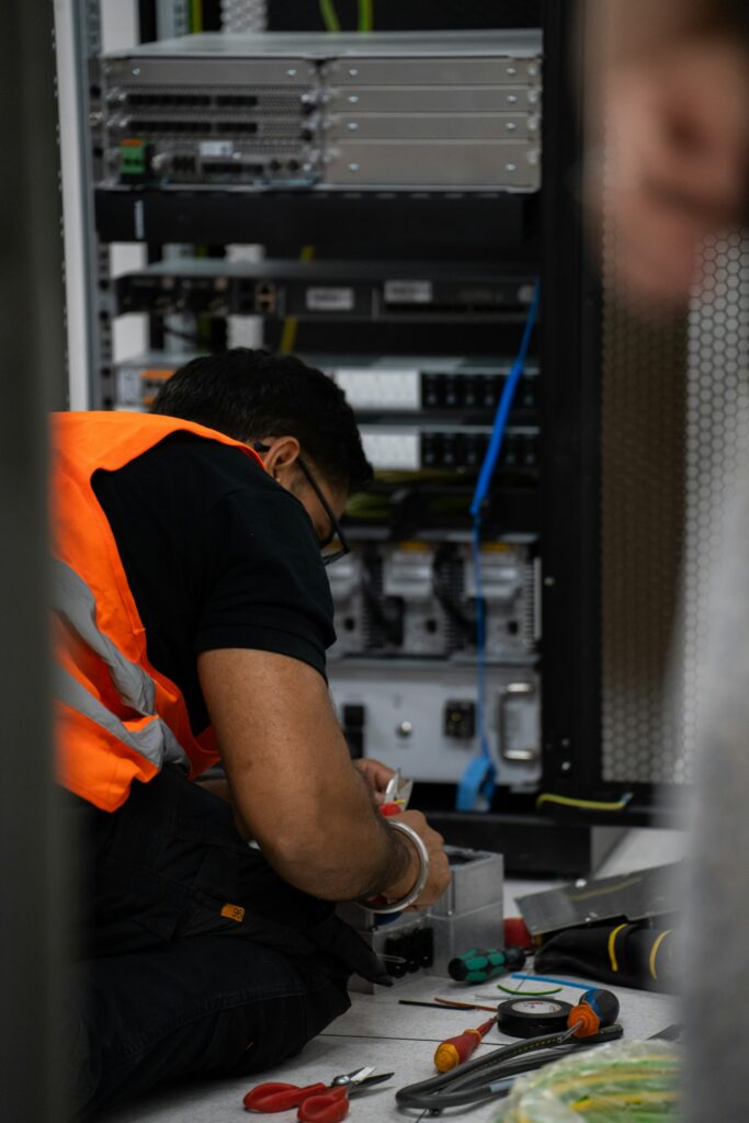 Technician working in a network rack